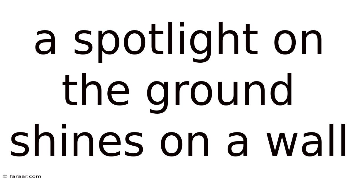 A Spotlight On The Ground Shines On A Wall